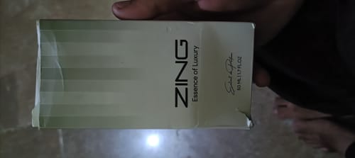 Customer holding the white and green box for the Milky Way perfume.
