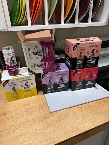 Reviewer's haul of seltzers on a counter, with a box of Ruby Grapefruit THC Seltzer visible.