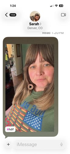 Close-up of a customer wearing the green Dog Bless — Premium Tee with its hot dog American flag graphic.