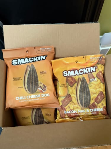 Customer's order of SMACKIN' sunflower seeds in a box, showing Chili Cheese Dog and Bacon Mac & Cheese bags.