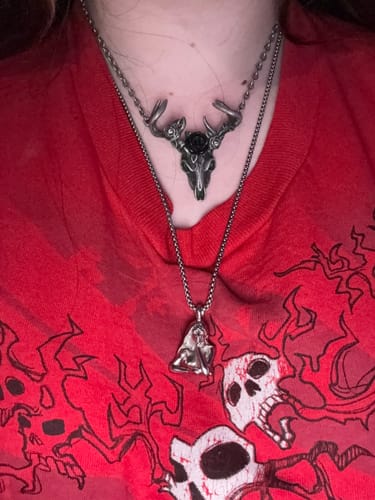 Customer wearing the silver Succubus Pendant on a chain, layered below another necklace.