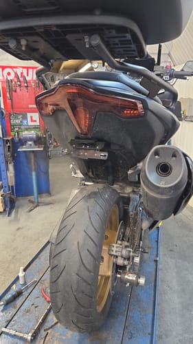 Customer's Yamaha T-max 560 in a workshop, showing the newly installed, minimal tail tidy that sharpens the bike's rear end.