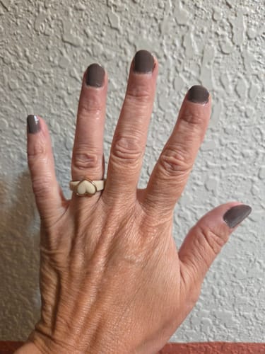 Reviewer's hand showing the white silicone ring from the Heart Frame Collection.