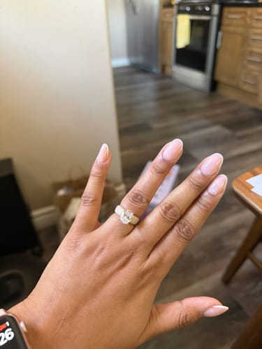 Reviewer's hand wearing the GlowStone silicone ring with its large oval-cut stone.