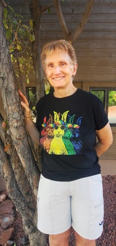 Reviewer smiling while wearing the black Pride Hares t-shirt with its colorful rainbow graphic.