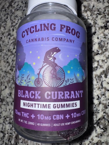 Customer's bottle of Black Currant Nighttime Gummies sitting on a granite countertop.