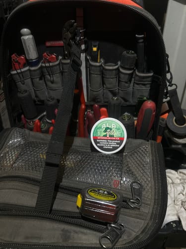 Customer's can of Drifters Watermelon Kiwi Ice Nicotine Pouches resting on top of an open tool bag.