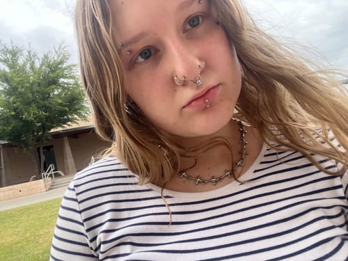 Customer wearing the silver-colored DYT Choker, which sits flat against the neck.