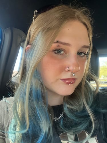Customer selfie showing the REAL 6TH CIRCLE OF HELL SEPTUM piercing worn in their nose.