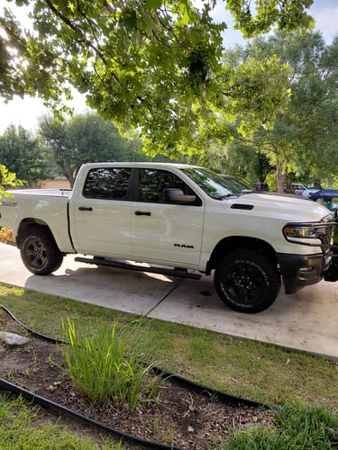 Customer's white Dodge Ram 1500 with a level lift after installing the upper control arms.