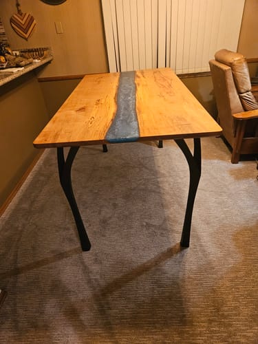 Customer's Faras counter table legs on a custom pecan and blue epoxy dining table in a home setting.