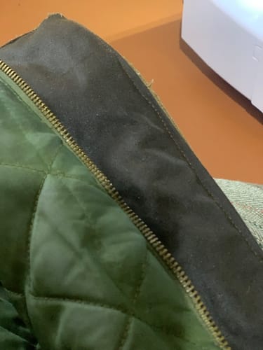 Customer's close-up of a tweed coat collar repaired with the dark waxed cotton fabric.