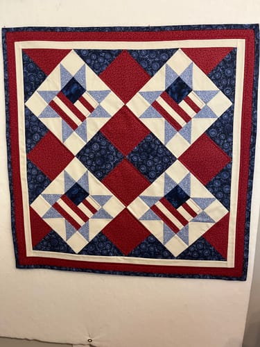 Reviewer's completed patriotic table square made from the Land of Liberty Quilt Kit.
