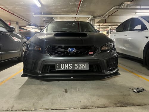 Reviewer's dark grey car with the slim Euro Premium Number Plate Bracket installed on the front bumper.