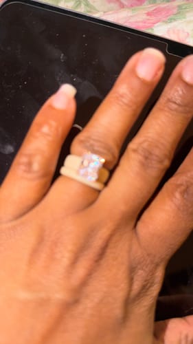 Close-up of a reviewer's hand wearing the Emerald Cut CZ Silicone Ring Set.