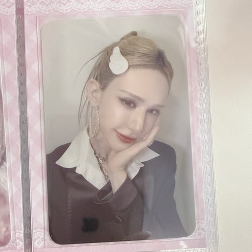 Customer's close-up of the XLOV "I,God" photocard, showing a person with a white hair clip smiling.