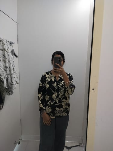 Reviewer takes a mirror selfie in a fitting room, showing the fit of the grey Airy Linen Wide Leg Pants.