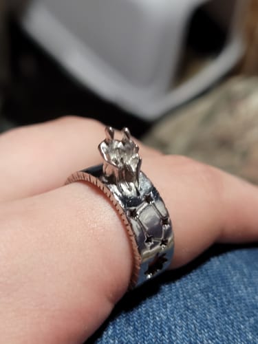 Close-up of a customer wearing the Stargazers Ring, showing the two figures and the star cutouts on the silver band.