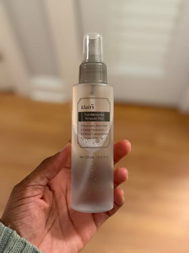 Reviewer holding the Fundamental Ampule Mist in a frosted, translucent spray bottle.