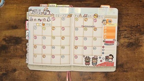 Customer's monthly planner spread for July decorated with adorable Summer Otters Days and Date Cover stickers.