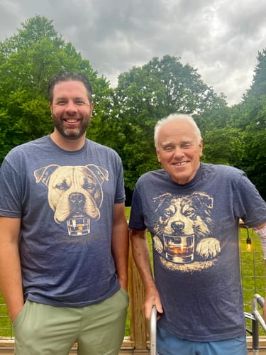Customer's image of two people, one wearing the blue Whiskey Australian Shepherd Grunge T-Shirt.