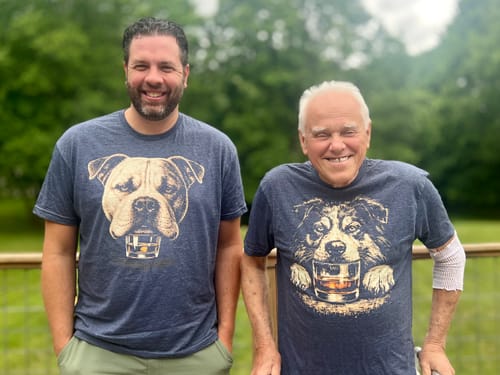 Customer wearing the blue Whiskey Dog American Bulldog T-Shirt next to a person in a similar graphic tee.