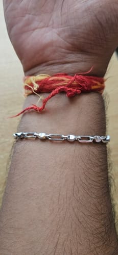 Close-up of a reviewer wearing the Silver Heshe Bracelet on their wrist.