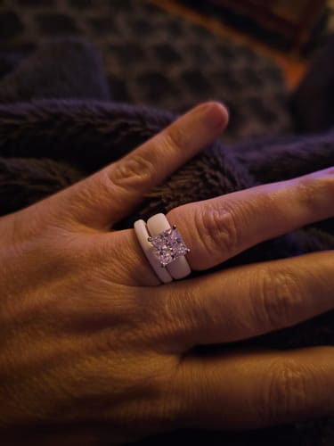 Reviewer wearing the two-piece white silicone ring set, highlighting the sparkling princess-cut stone.