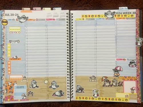Reviewer's open planner decorated for a July week with cute Beach Birds stickers from the Ultimate Subscription kit.