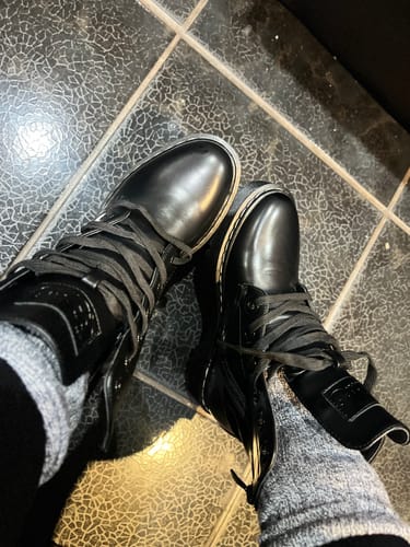 Customer's overhead view of the black Miss Black Nirvana 4 Ankle Boots worn with thick socks.