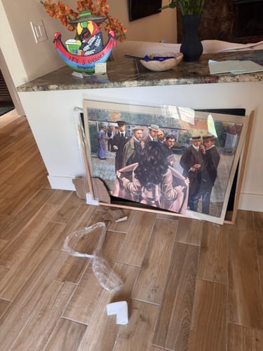 Customer's Dark Oak Gallery Frame, which arrived broken and is leaning against a counter with pieces on the floor.