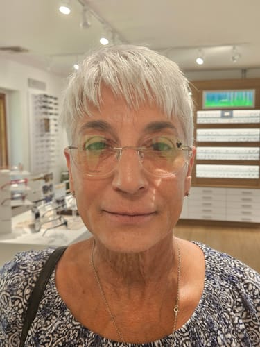 Reviewer showing their face and neck, highlighting healthier-looking skin after using the Micro Infusion System.