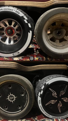 Customer's new Meepo Cyclone 107s Rubber Wheels shown for comparison next to their old Possway wheels.