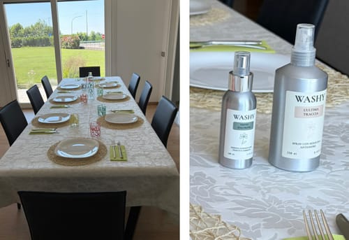 Il cliente mostra lo spray L'Ultima Traccia e un altro profumatore su una tavola apparecchiata con cura.