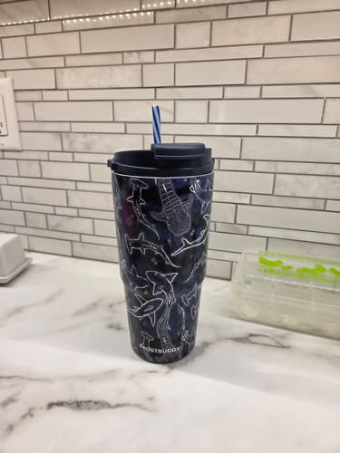 Reviewer's dark blue To-Go Buddy with a white shark pattern, shown on a marble countertop.