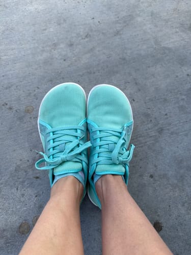 Customer's overhead view of their turquoise Luck Ⅰ - Barefoot Shoes on a paved surface.