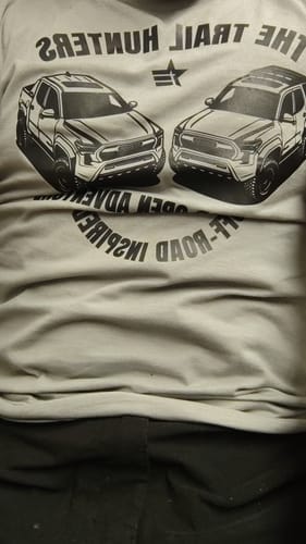 Close-up of a reviewer showing the fit of their Limited Edition ENR#83 Tee with a large truck graphic.