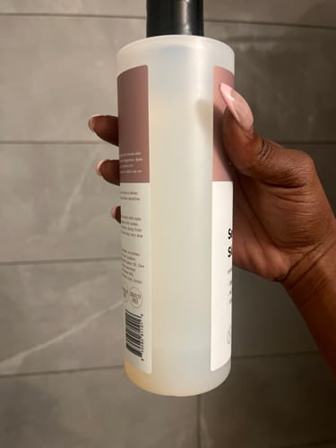 Reviewer holding a nearly empty bottle of Sensitive Skin Soother Hypoallergenic Body Wash.