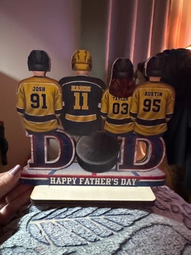 Customer's personalized wooden hockey plaque for Father's Day, showing a dad and three kids in custom jerseys.