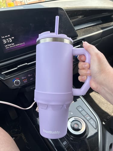 Customer holding the lavender Thicc Buddy 40oz mug in a car, showing how the rubber adapter ring is stored.