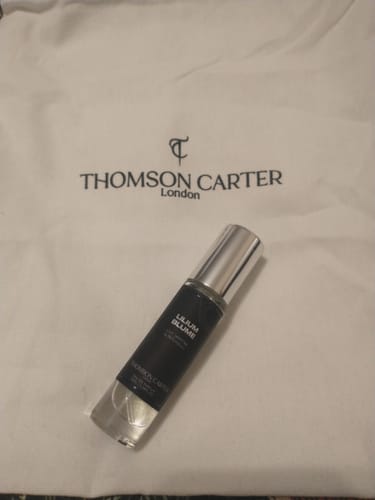 Customer's tester bottle of Lilium Blume Eau de Parfum resting on a white Thomson Carter London bag.