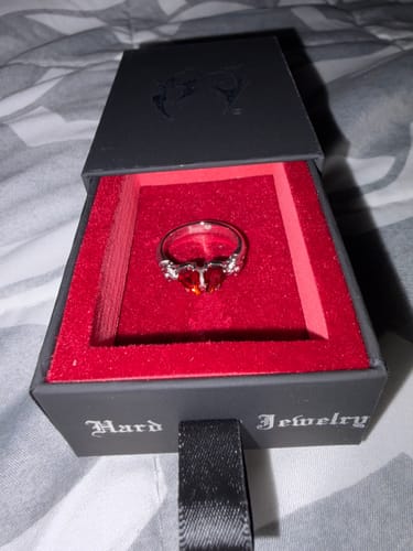 Reviewer's Mini Promise Ring inside its black box with a red interior.