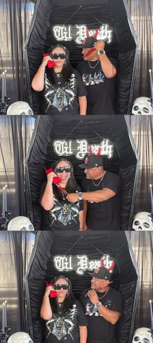 A customer and friend wearing the black 9 Year Anniversary Shirts, posing together in a fun photo booth.