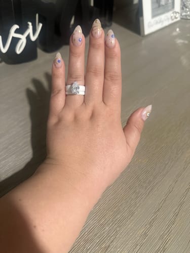 Customer's hand wearing the white stackable Pear Cut CZ Silicone Ring Set.
