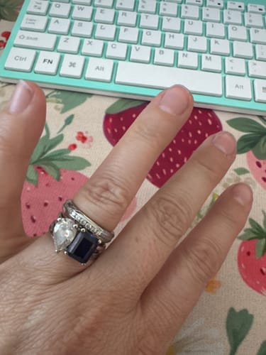 Customer's Channel Setting Eternity Ring worn at the top of a three-ring stack on their finger.