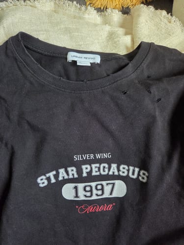 Customer's close-up of the black Star Pegasus dress, showing the printed chest graphic and distressed collar detail.