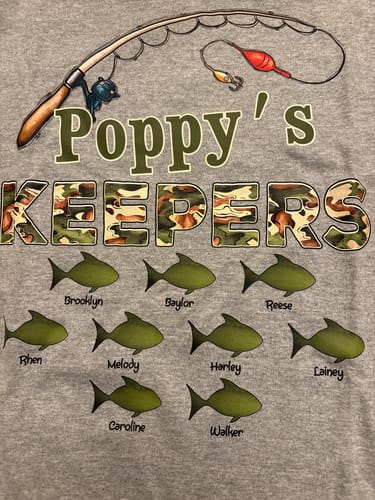 Customer's personalized gray 'Poppy's Keepers' fishing shirt with nine fish graphics customized with grandchildren's names.