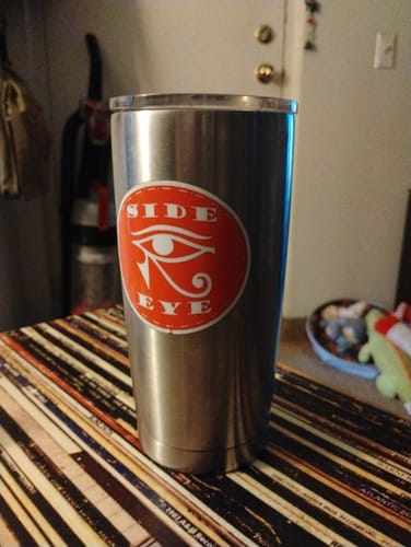 Reviewer's custom vinyl sticker with a red circular 'SIDE EYE' design applied to a stainless steel tumbler.