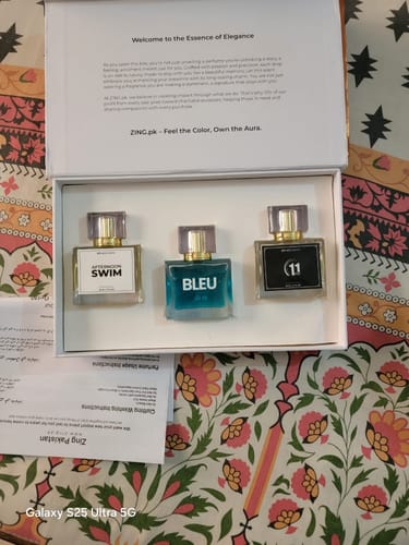 Customer's open Summer Box showing the three perfume bottles: Afternoon Swim, Bleu, and 11, arranged neatly inside.