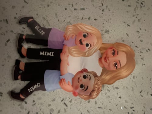 Customer's personalized acrylic fridge magnet showing a grandma, Mimi, being hugged by two grandkids, Ellie and Owen.